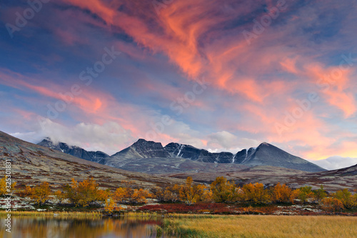Sunset over Rondslottet mountain in Rondane National park, Norway, Europe