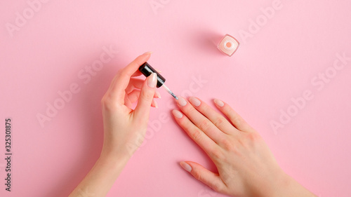 Quadro su tela Woman applying polish on nails at home