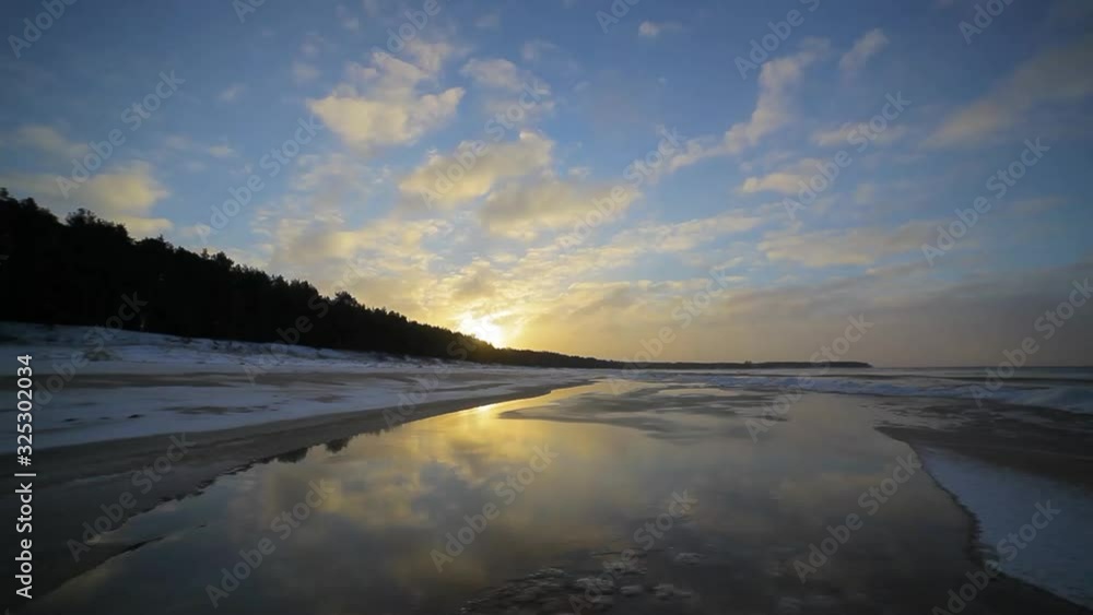 Spectacular sunset light at winter seashore with ice Spectacular sunset light at winter seashore with ice