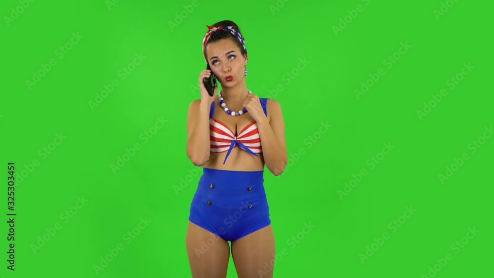 Beautiful girl in a swimsuit is talking for mobile phone. Green screen Beautiful girl in a swimsuit is talking for mobile phone. Green screen
