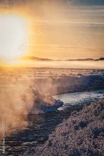 sunset on the river in foggy frosty winter in Iceland