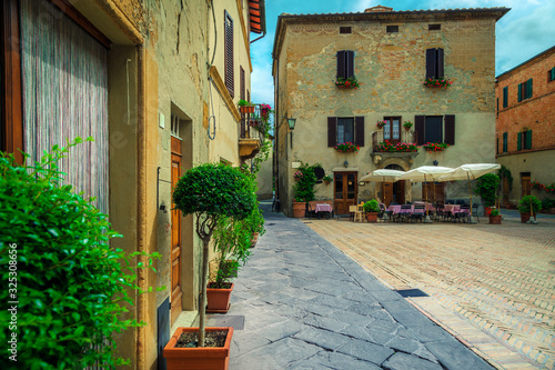 Fototapeta Naklejka Na Ścianę i Meble -  Cozy street cafe with outdoor furniture in Tuscany, Pienza, Italy