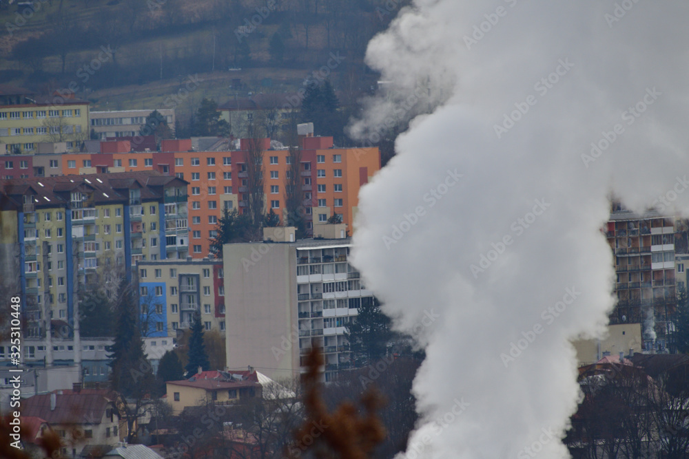 Smoke from the chimney of the thermal power plant rises above the city and pollutes nature