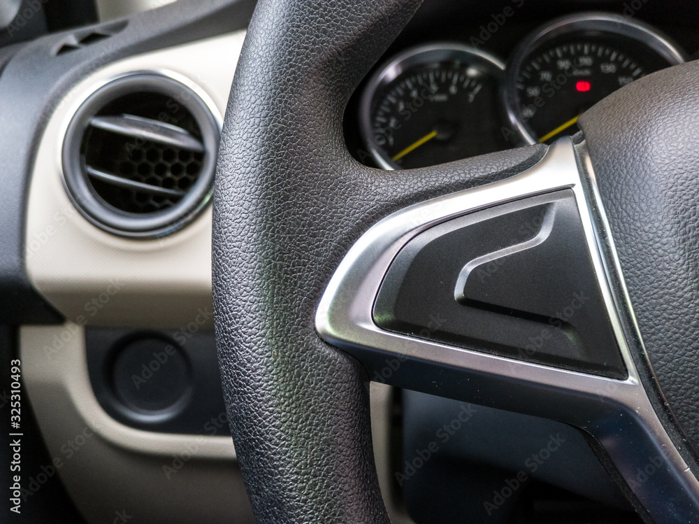 Modern luxury car Interior  steering wheel and dashboard speedometer display.