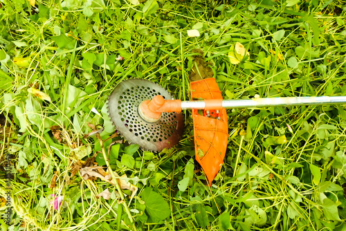 Mowing grass with an old gas mower. Seasonal garden cleaning with a lawn mower concept