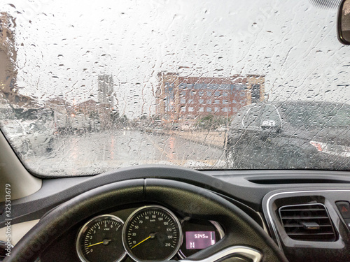 rain on car windshield in rainy season