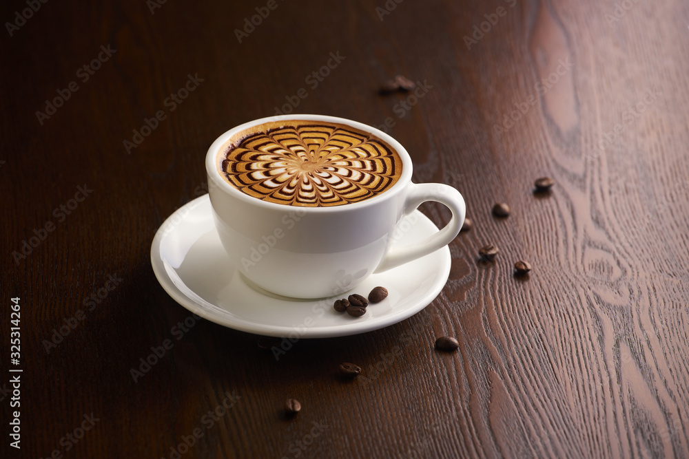 Fototapeta premium Cup of latte or Cappuccino on table in cafe.