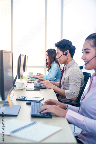 Group of young teamwork businesspeople with headset and computer at office.