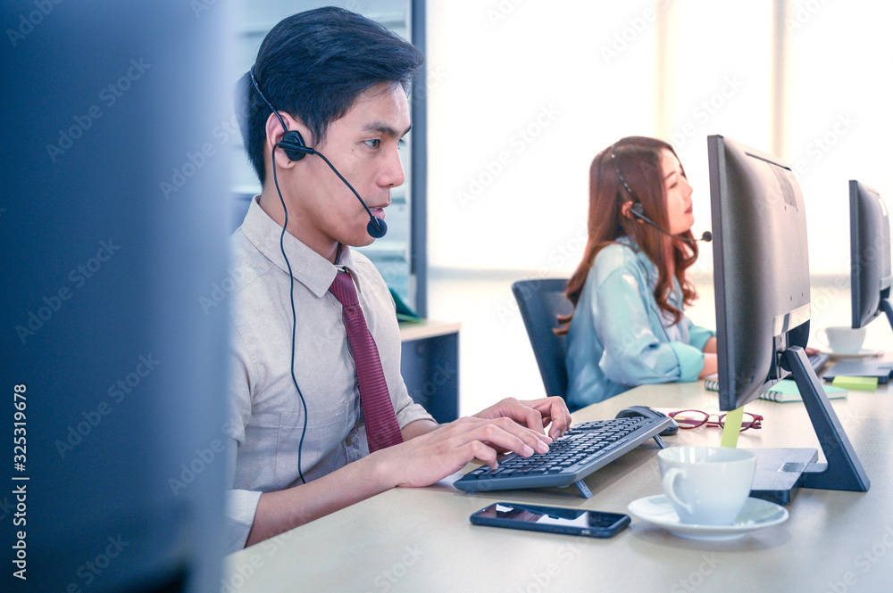Young customer service men agent with headsets and computer working at office. Young customer service men agent with headsets and computer working at office.