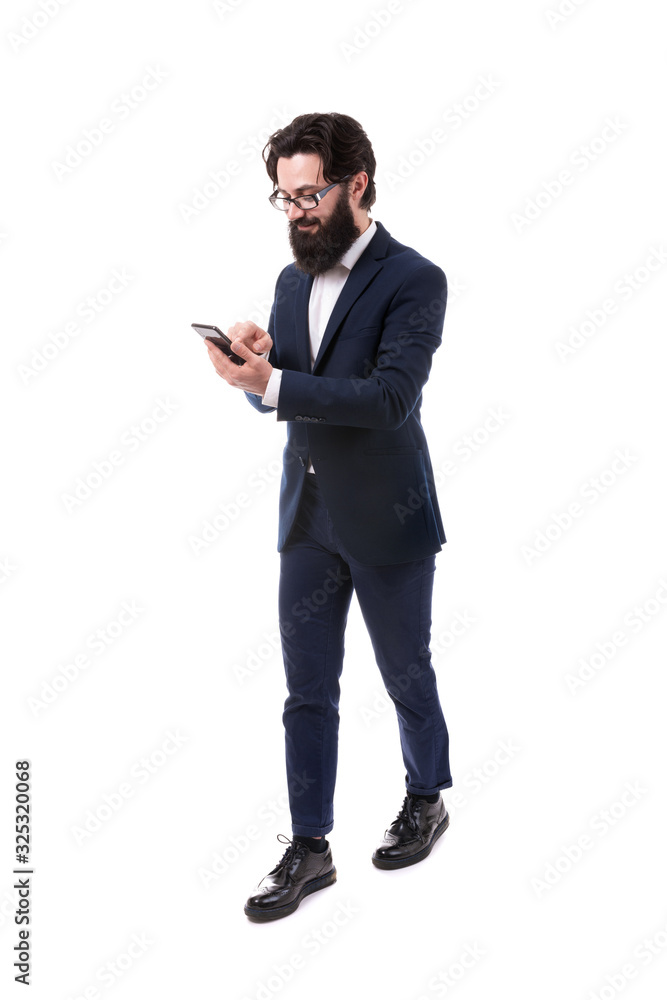 Full length portrait of a bearded businessman with a smartphone, isolated on white background Full length portrait of a bearded businessman with a smartphone, isolated on white background