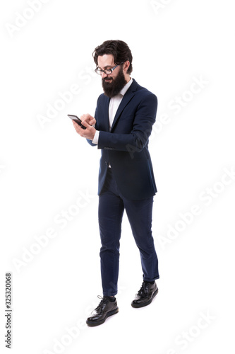 Full length portrait of a bearded businessman with a smartphone, isolated on white background