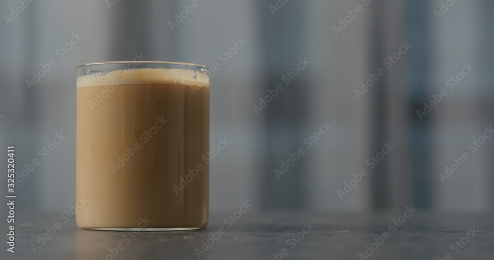 coffee with cream in glass on concrete countertop coffee with cream in glass on concrete countertop