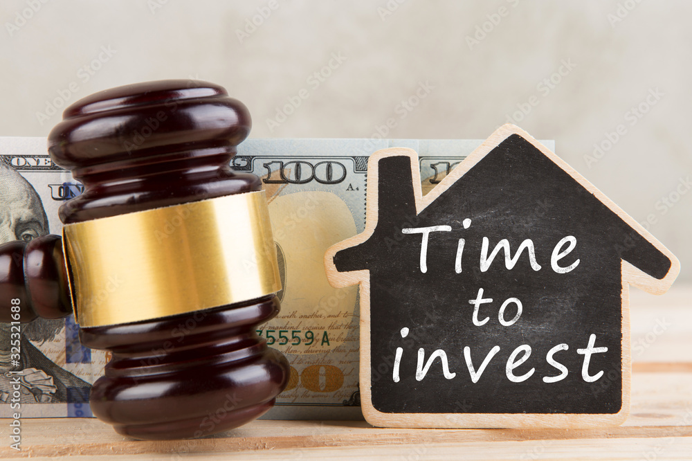 Real estate concept - Time to invest, gavel and house model