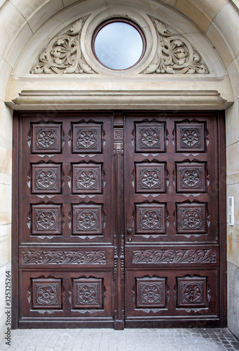 Wooden arched doors surrounded by stones in medieval design