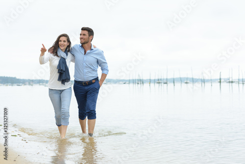 couple walking along the tideline