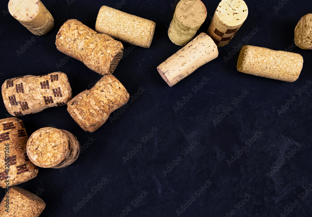 wine corks on a black textured surface. top view. place for text