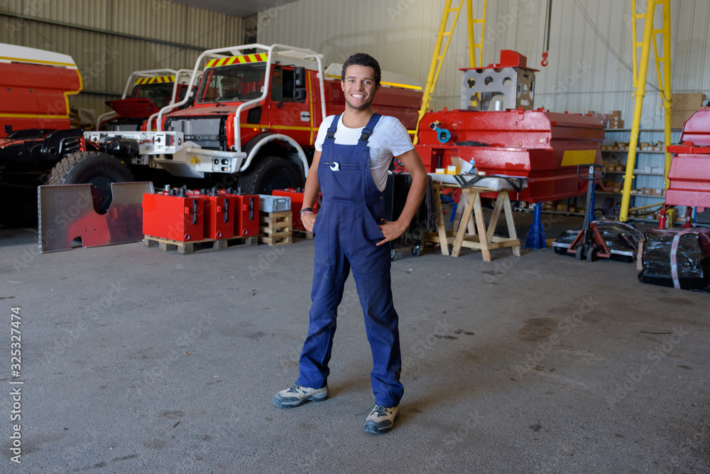 young male firetruck mechanic posing