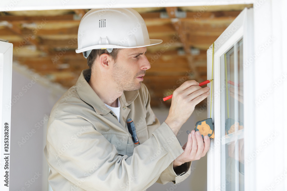 repairman taking measures with tape measure light effect repairman taking measures with tape measure light effect