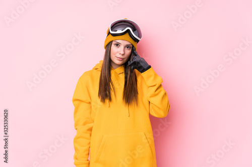 Young caucasian skier woman isolated pointing temple with finger, thinking, focused on a task.