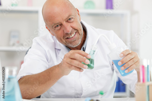 mature lab worker conducting a chemical experiment