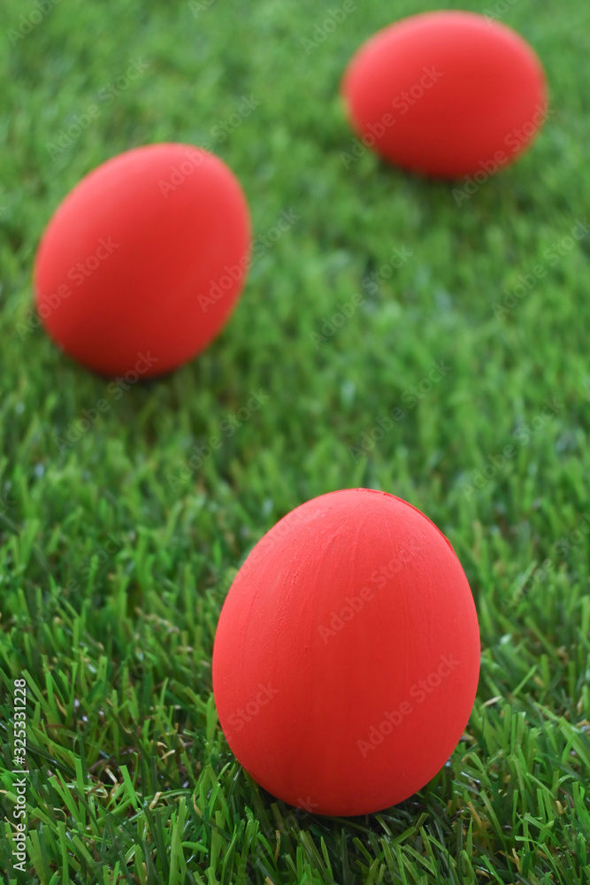 red easter egg on lawn green grass artificial, image of morning springtime concept