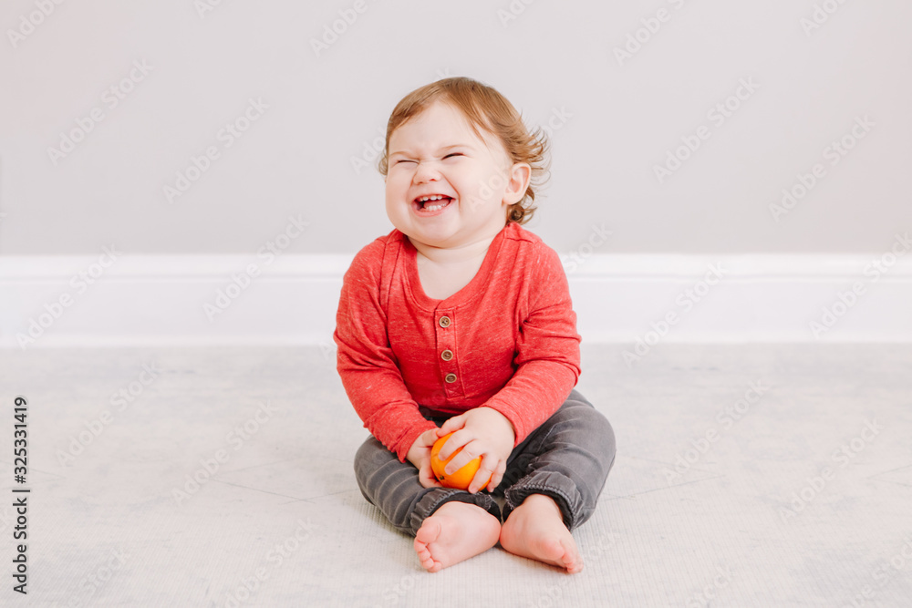Cute adorable Caucasian baby boy eating citrus fruit. Finny child eating healthy organic snack. Solid finger supplementary food for children toddler. Cute adorable Caucasian baby boy eating citrus fruit. Finny child eating healthy organic snack. Solid finger supplementary food for children toddler.