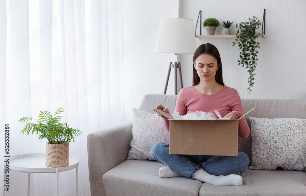 Young girl unpacking box and feeling frustrated Young girl unpacking box and feeling frustrated