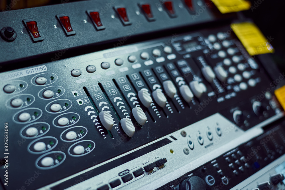 Audio music mixer console on a black background. Sound studio mixing desk