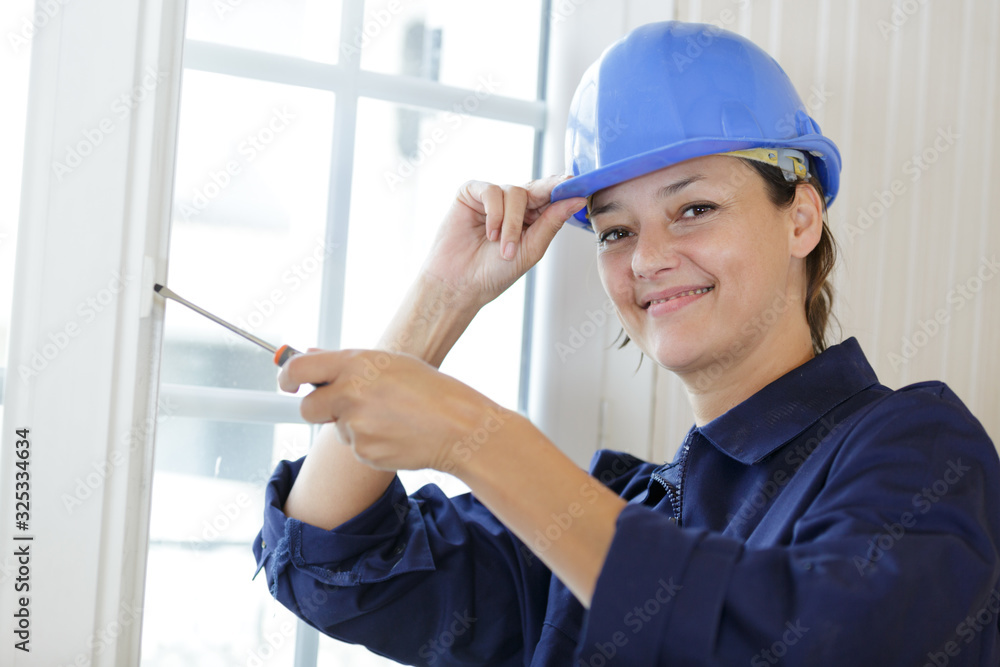 young woman builder working using a screwdriver young woman builder working using a screwdriver
