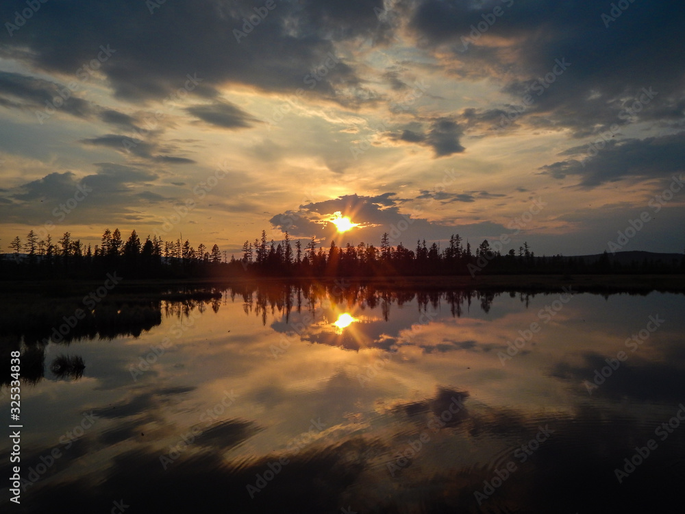Fototapeta premium sunset in clouds above the surface of the lake