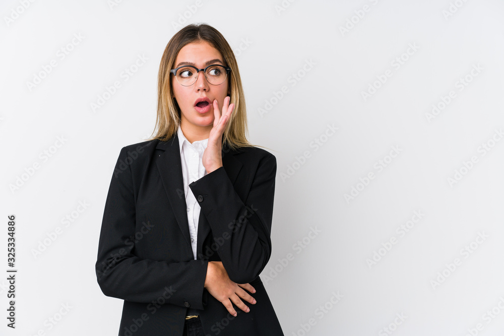 Young business caucasian woman is saying a secret hot braking news and looking aside Young business caucasian woman is saying a secret hot braking news and looking aside