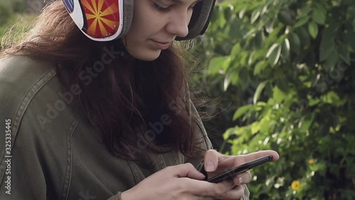 Girl traveler text a message on the phone stopping on a bike at the edge of the road at sunrise
