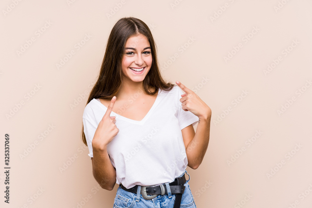 Young caucasian woman posing isolated smiles, pointing fingers at mouth. Young caucasian woman posing isolated smiles, pointing fingers at mouth.