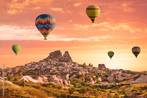 Colorful hot air balloons flying over the valley at Cappadocia  Uchisar  Turkey. Volcanic mountains in Goreme national park