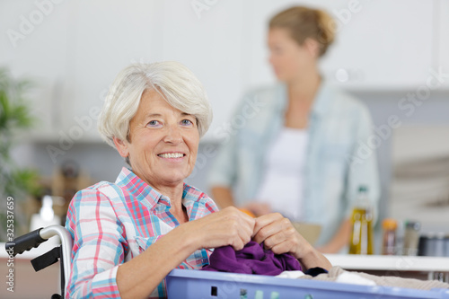 mature woman doing a laundry