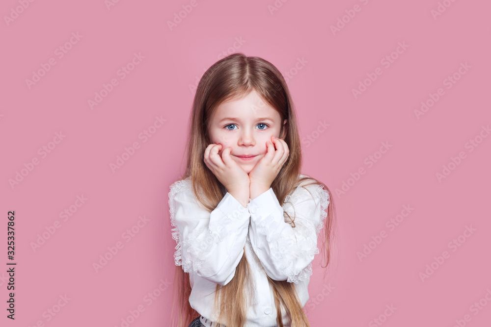 charming adorable little girl holding hands under her chin charming adorable little girl holding hands under her chin