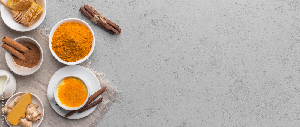 Fototapeta premium Turmeric in different shapes curcuma powder on gray