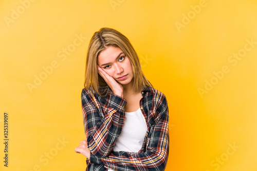 Young blonde caucasian woman isolated who is bored, fatigued and need a relax day.