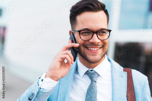 Young business man talking on the phone.