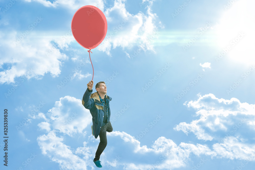 the concept of carefree and life enjoy, dream come true, person with balloon fly high in the air