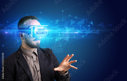 Businessman looking through Virtual Reality glasses with SMART SECURITY inscription, cyber security concept