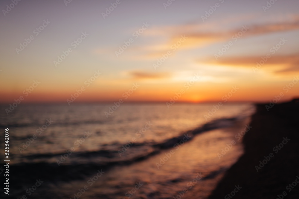 Blur sunset beach with bokeh sun light wave abstract background. Travel concept. Blur sunset beach with bokeh sun light wave abstract background. Travel concept.