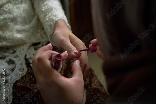 nail polish applied on hands of the bride 