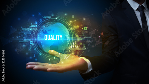 Wallpaper Mural Elegant hand holding QUALITY inscription, digital technology concept Torontodigital.ca