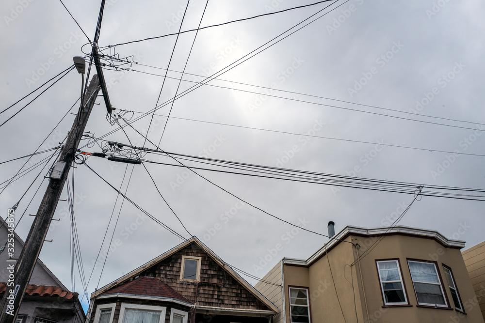 electrical wires and houses with gray skies electrical wires and houses with gray skies