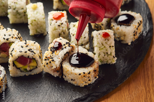 Various kinds of sushi roll set served on black stone. Japanese food