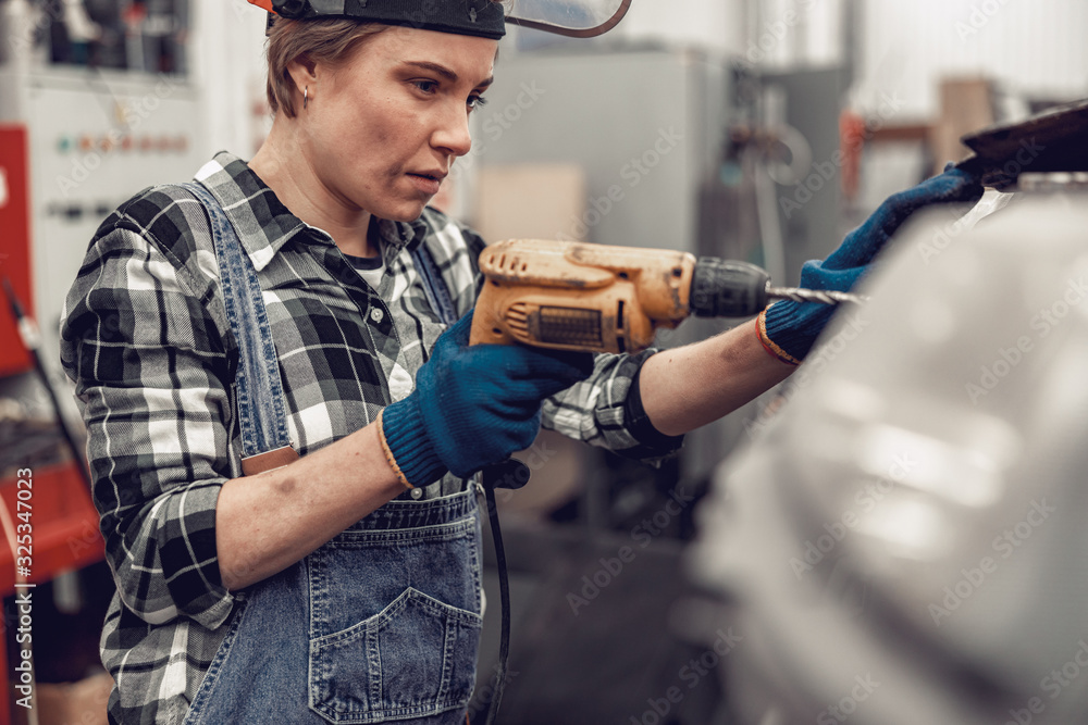 Focused young auto technician repairing a car Focused young auto technician repairing a car