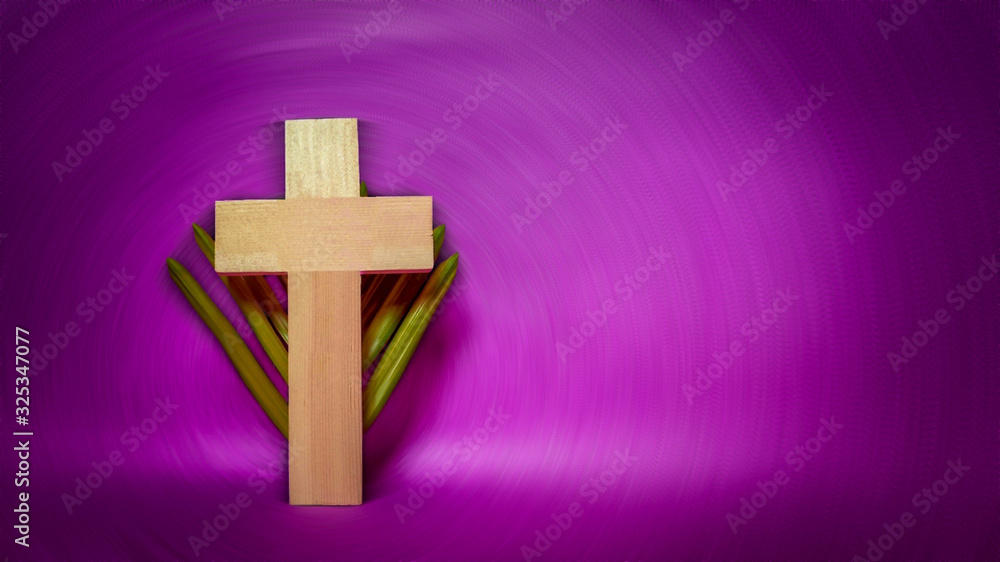 Lent Season,Holy Week and Good Friday concepts - photo of cross shape made of wood with palm leave in vintage purple background