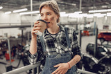 Young Caucasian woman drinking coffee at work