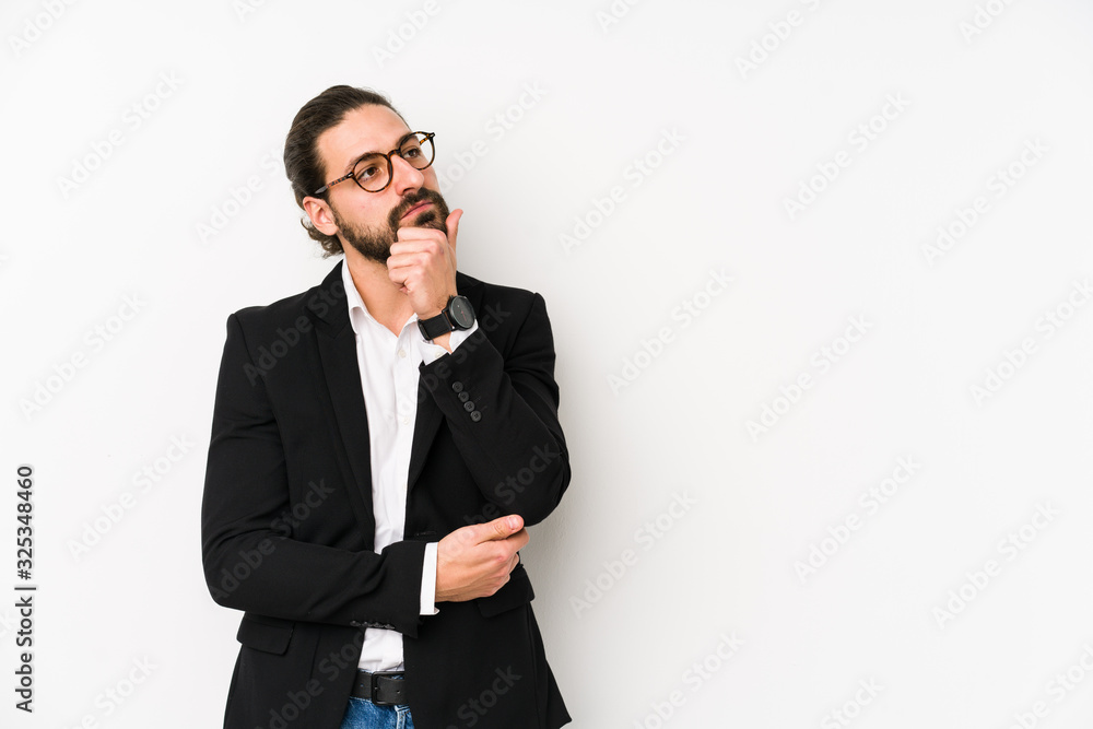 Young caucasian business man isolated on a white background looking sideways with doubtful and skeptical expression. Young caucasian business man isolated on a white background looking sideways with doubtful and skeptical expression.